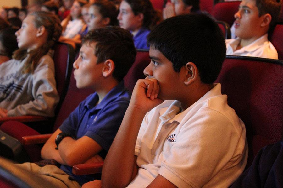 Sixth graders Aadi Patel (right) and Brandon Baklayan watch Screenagers with the rest of the middle school in the BPAC.