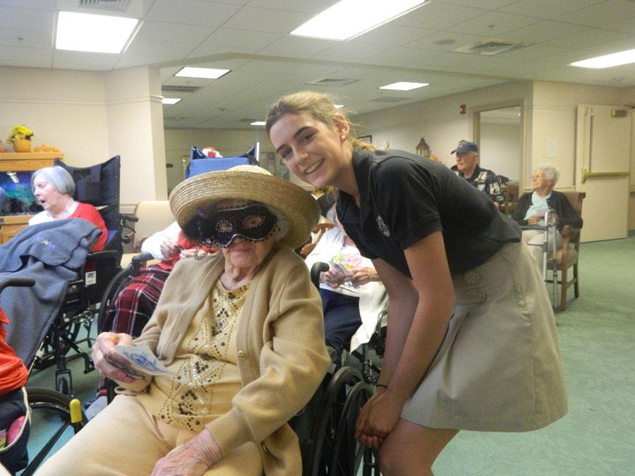 Seventh grader Emma Johnson poses with one of the Waterford residents who was feeling the festive spirit of Halloween.