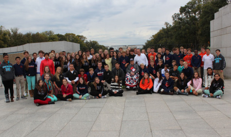 TBS students surround Mr. Theodore Majewski Sr. (center), at the WWII Memorial. Mr. Majewski,  along with other WWII veterans, took an honor flight to see the memorial.