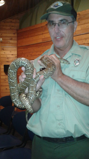 One of the park employees holds "King Henry," the king snake that lives at the park's education center.