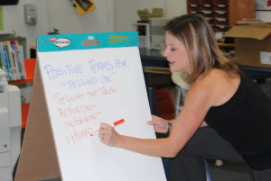 ADL representative Tracey Grossman writes down examples of "telling on," an alternative to the word "tattling" which has a negative connotation for students. Students are encouraged to "tell on" if they see bullying or behavior that could lead to someone getting hurt at school.