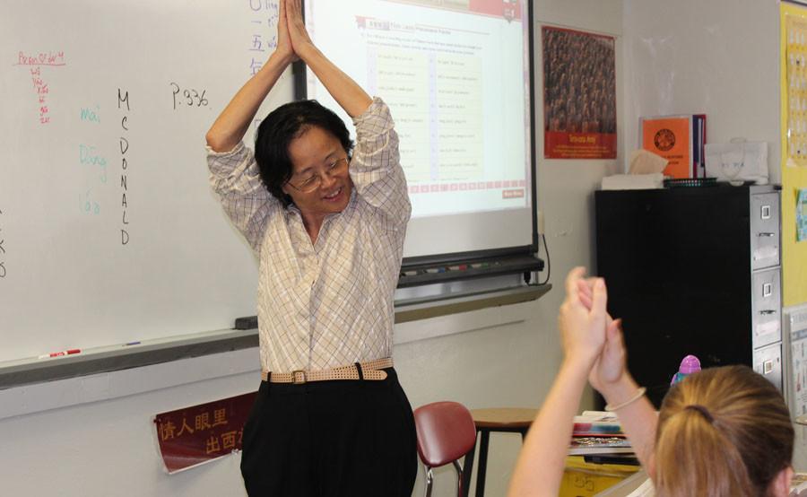 While teaching her C period about Chinese culture, Mrs. Kantor leads her students in a dance movement