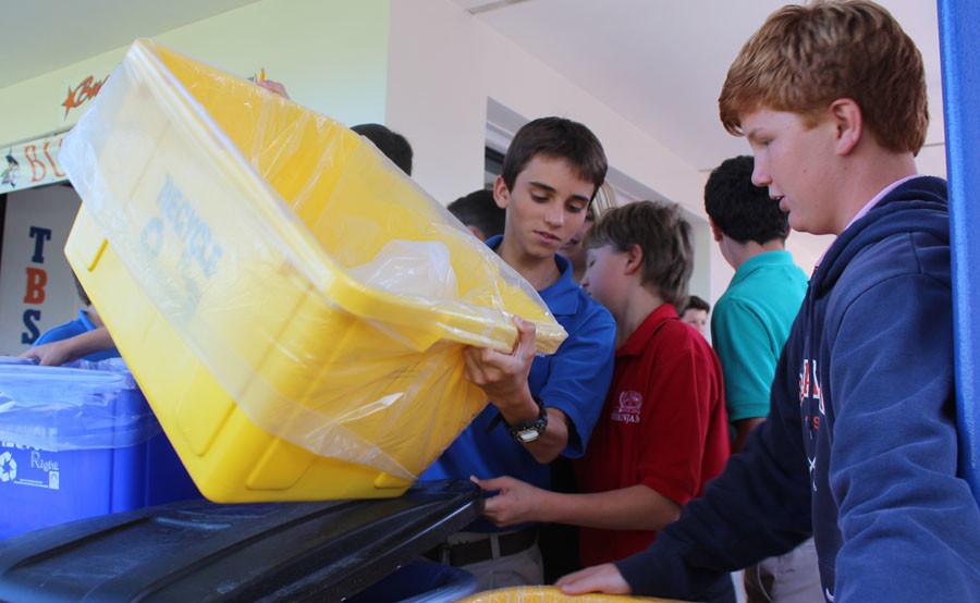 Eighth graders Ryan ONeill (left) and Rigby Peckham empty their class recycling bins into the larger bins outside the Buc Café.