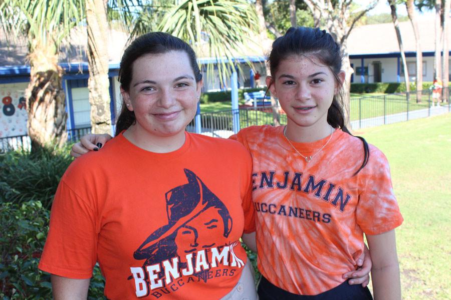 Seventh graders Crystal Pauldo and Jordan Wheaton show off their orange school spirit shirts during break on Wednesday, October 7.