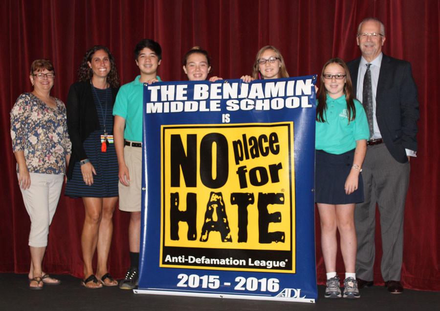 Left to right: Science Department Chair Ms. Gabriele St. Martin, Student Services Coordinator Ms. Danielle Benvenuto, Student Council President Nicolas Lama, Student Council members Demi den Bakker, Briley Crisafi, and Olivia Beam, and Head of School Mr. Robert Goldberg display the banner from the ADL.