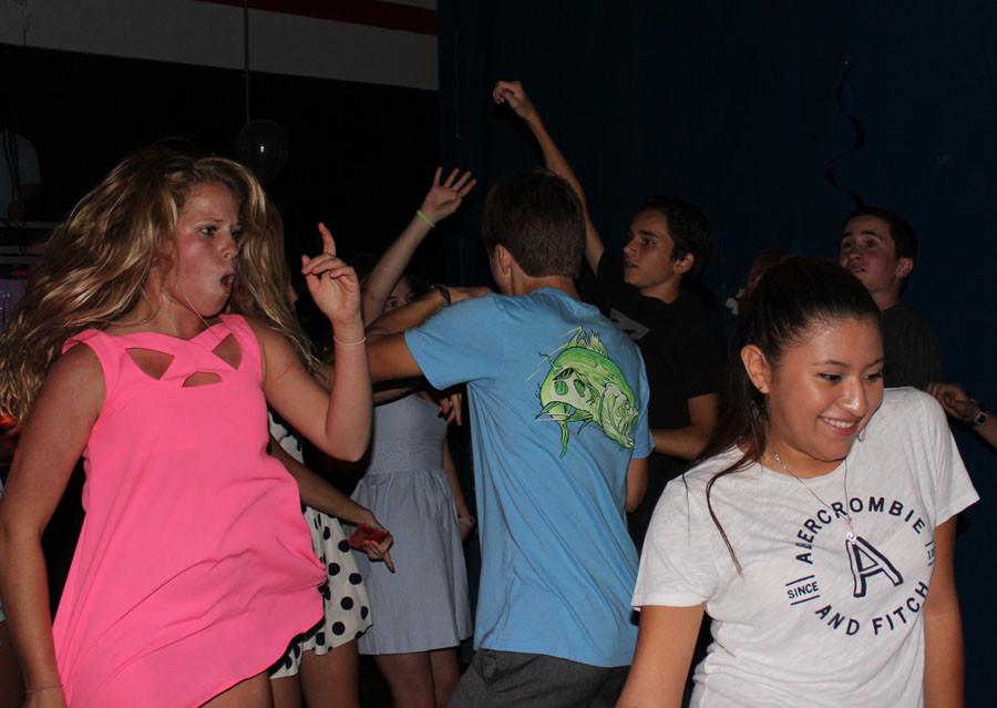 Eighth graders Phoebe Denenberg (left) and Molly Sullivan break it down on the dance floor with the rest of their classmates.