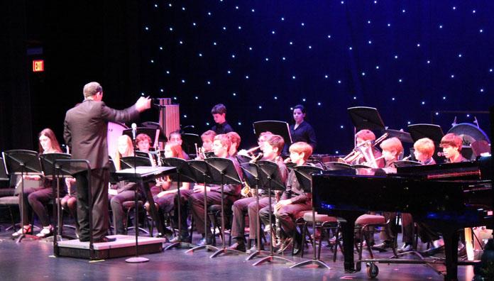 Mr. Huber conducts the middle school bands during the concert.