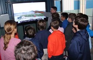 Mr. Elkins points out specific parts of the new REF 2 facility  to the sixth graders on a time lapse video that shows the months of construction in only a few minutes.
