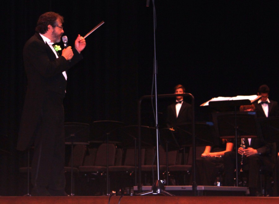 Dr. Nagy gestures to the Upper School Band while addressing the audience during the festival.