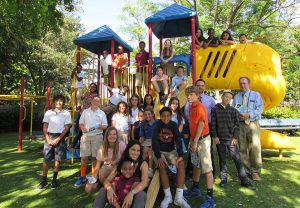 The Adopt-A-Family students in the Grow, the organization's after school program, pose with Mr. Crisafi's and Mr. Winter's advisees on the playground at the West Palm Beach facility.