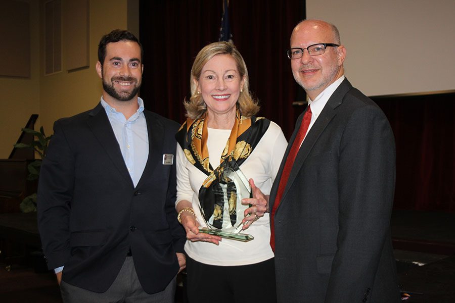 Sean Dollard of Adopt-A-Family (left) presents Director of Student Services Mrs. Susan Poncy and Head of Middle School Mr. Charles Hagy with a special award for  The Benjamin Schools involvement this year.