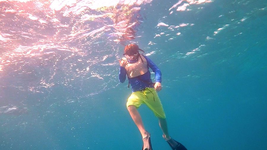 Seventh grader Casey Zecca flashes the hang ten sign while on one of the coral reef dives.