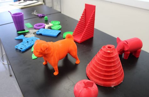 The table at the front of Ms. St. Martin's classroom displays the various objects that have been printed thus far.