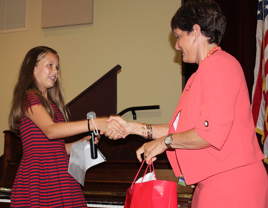 Treasurer Emeline Smith accepts a gift from Mrs. Corey after making her speech on September 19. All of the candidates received a small congratulatory gift from Corey for running for office.