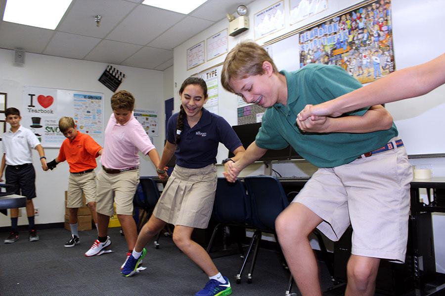 Eighth graders Skyler Zur (center) and Jake Mendelsohn (right) can't keep a straight face as they try not to fall into the Boiling Pit of Spaghetti in Mr. Crisafi's Journalism and Web Media class.
