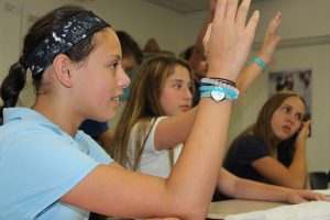 Seventh grader Sophia Smith raises her hand to answer a question after the students' FaceTime session with Rios Vergara.