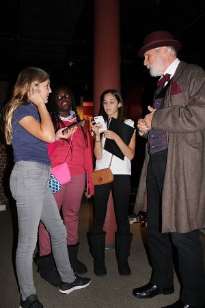 Left to right: Nadia Poncy, Danai Makoni, and Sydney Fox listen to an actor at the Ford's Theater Museum.