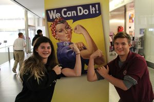 Hudson Hale and Jordan Wheaton pose in front of Rosie the Riveter