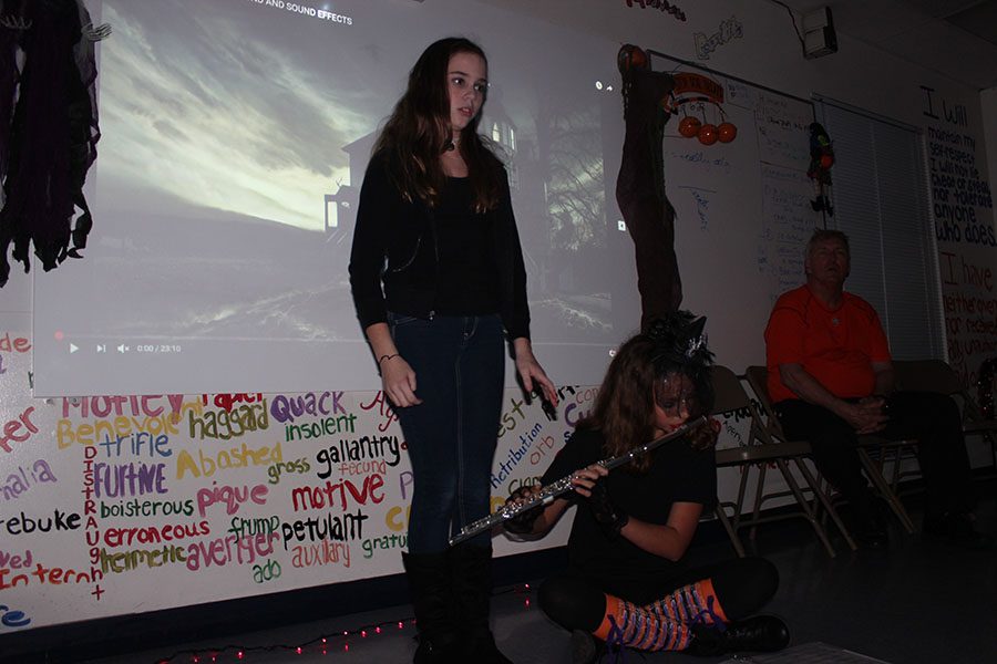 Seventh grader Catherine Schenk reads a poem to eerie music via the flute played by fellow seventh grader Ella Pierman.