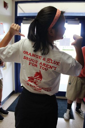 Eighth grader Carol Chen shows off her Red Ribbon Week t-shirt on Friday, October 28.