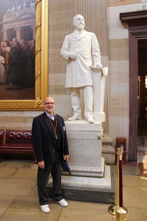 Mr. Hagy stands by one of his historical heroes, former President James Garfield, at the Capitol Building.