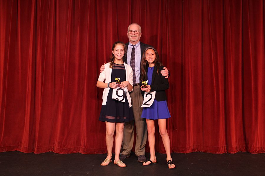 Head of School Mr. Robert Goldberg poses on the BPAC stage with winner Bryce Weisser (right) and runner-up Emilie Dubiel.