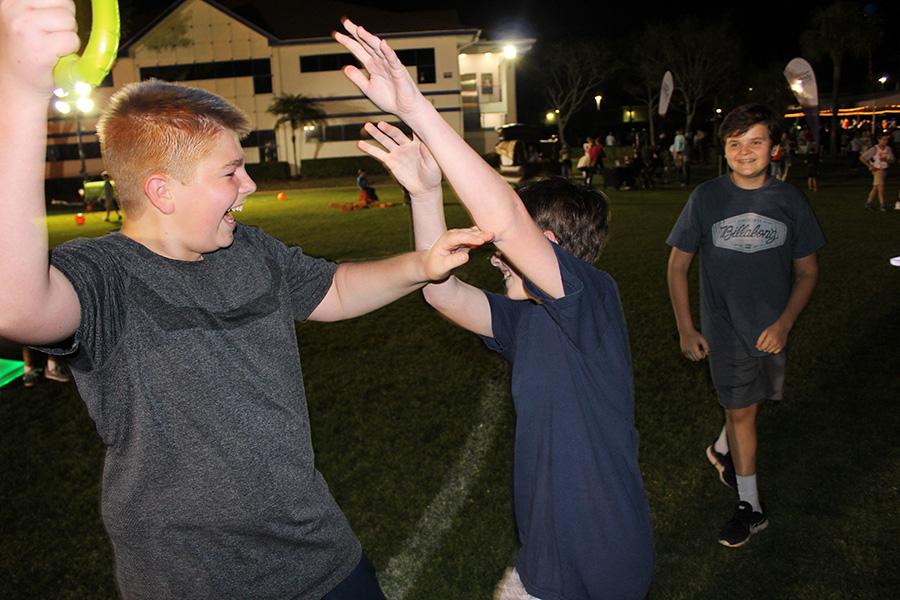 Eighth grader Erik Bernhardt has fun brandishing a blow-up sword as fellow classmate Nico GRaziotto tries to defend himself and Tommy Rose looks on.