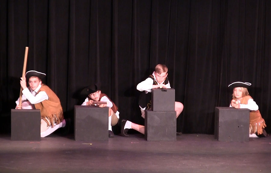 Left to right: Seventh grader Casey Crawford, seventh grader Jakob Kroll, eighth grader Robin Howley, and seventh grader Tyler Teaford play American revolutionaries getting ready to ambush the British in The Entire American Revolution (in 40 Minutes or Less).
