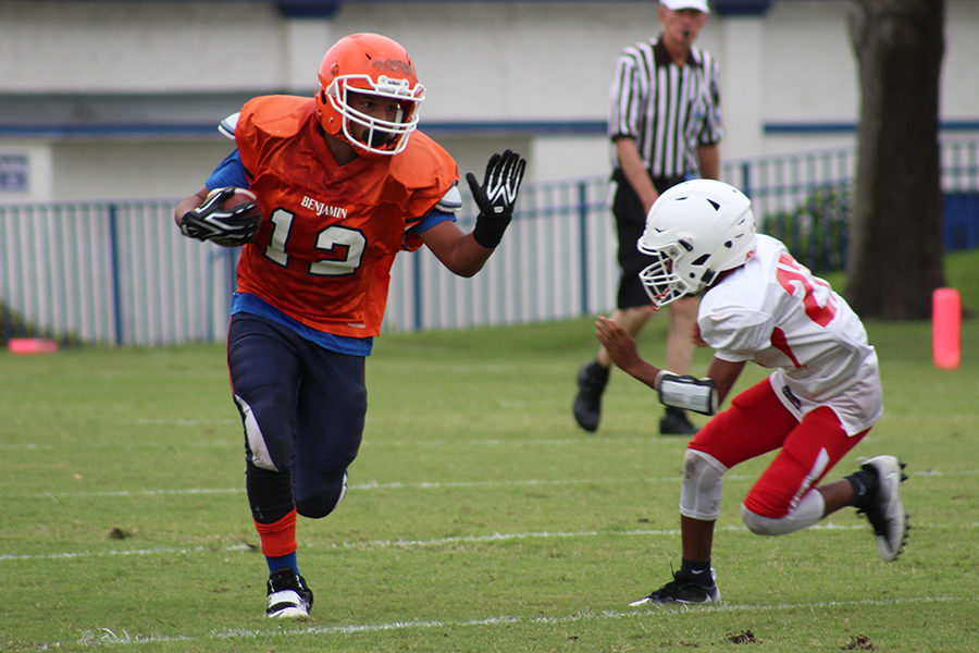 Brandon Powell  looks to stiff arm a defender during the Bucs 28-14 win over Westminster Academy on October 4.