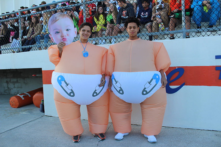 Eighth graders Camilo Saiz (left) and Matthew Roundtree pose in front of the bleachers as they wait for the Lower School Halloween Parade to begin.