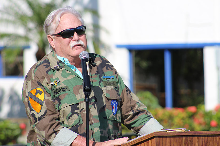 Mr. Todd Ruedisili, a former soldier in the United States Army, addresses the crowd on Kennerly Field during the Veterans Day ceremony.