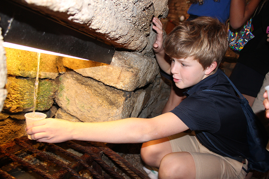 Sixth grader WIlson Stewart collects some drinking water from the Fountain of Youth during the grade's first stop in St. Augustine.