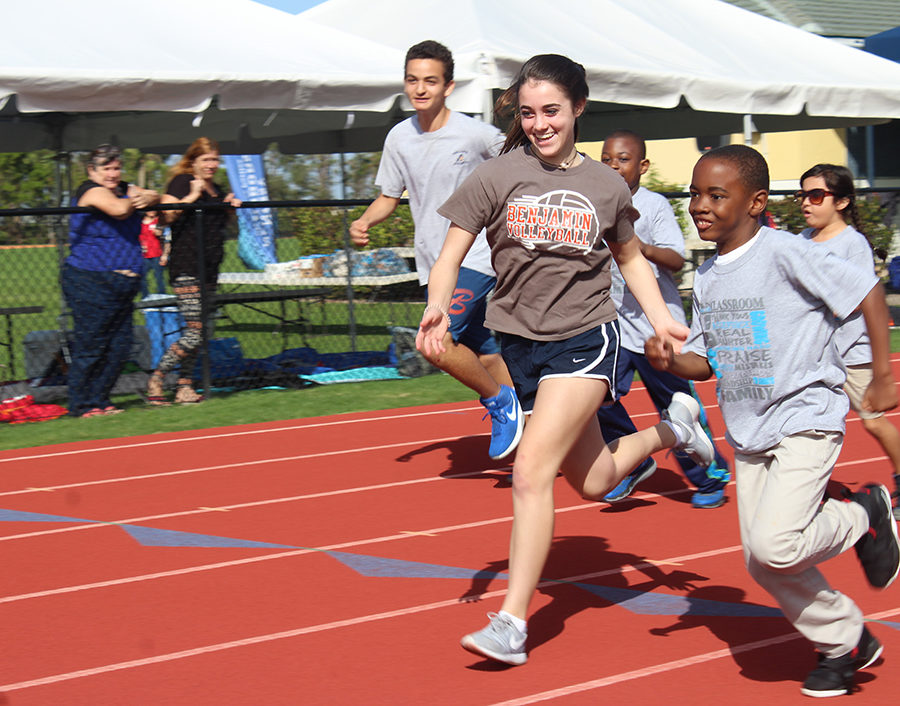 Eighth+graders+Ali+Brown+and+John+Vincent+Janin+help+some+of+the+special-need+students+run+the+100-yard+dash.