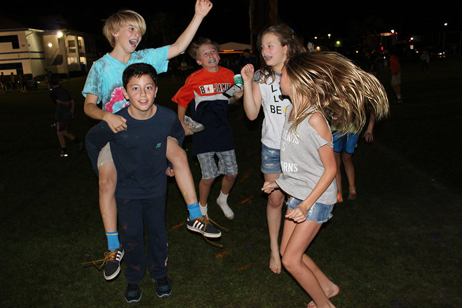 Sixth graders (left to right) Sloane McIlvaine, Luca Balzano, JP Jacobs, Zoe Cooper, and Mimi Chandler rock out to the music spun by the deejay at the Spring Kickoff.