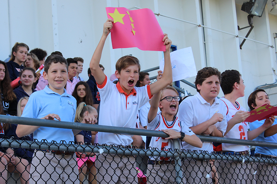 Sixth graders Arthur Wolff, J.P. Jacobs, Sam Storch, and Tim Mahon cheer for China and the other participants in the Lower School Olympics.