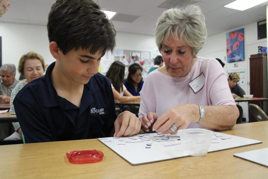 Eighth grader Jake Zur and his grandmother, Wendi Adler, create a poem with magnetic words in Mrs. Devines room on Grandest Friends Day.