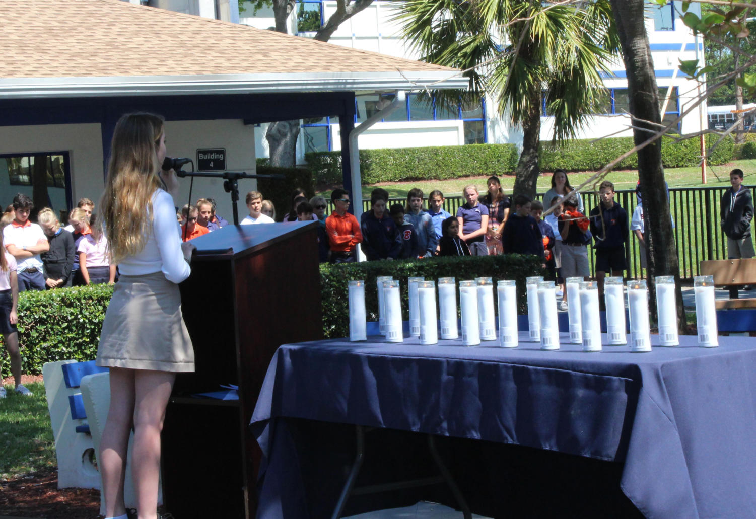 Amidst the 17 lit candles, eighth grader Catherine Schenk sings