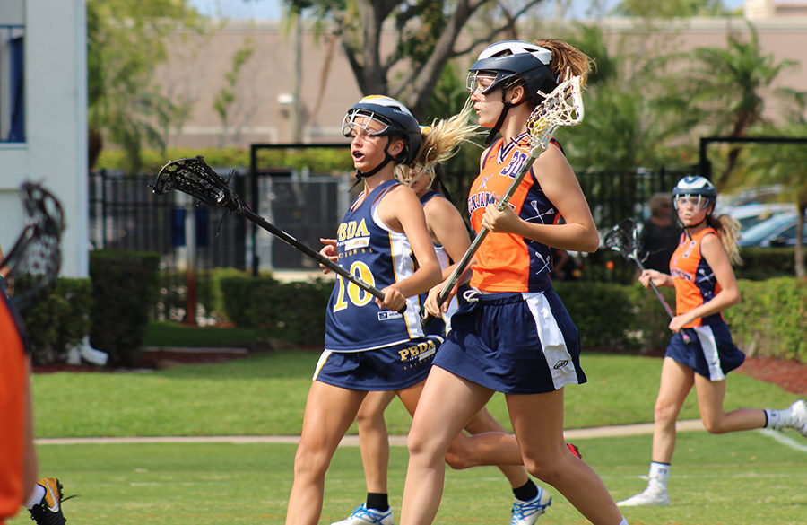 Although concussions are more likely to occur in boys lacrosse, some female players would welcome a more physical game. Here, eighth grader Eden Josza heads downfield against Palm Beach Day Academy during the league championship on Kennerly Field.