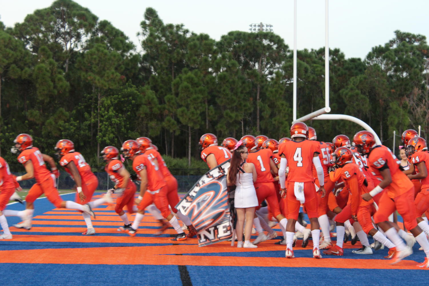 The Bucs' varsity football team run out onto the field prior to their Homecoming Game against John Carroll on October 5, 2018.