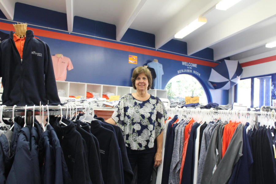 Ms. Rolanda Crawford stands inside the Nook surrounded by the apparel she keeps in stock for TBS families.