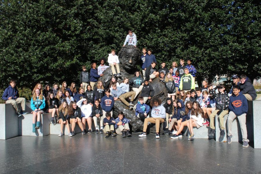 The entire eighth-grade student body poses on and around the Albert Einstein statue before departing D.C. 