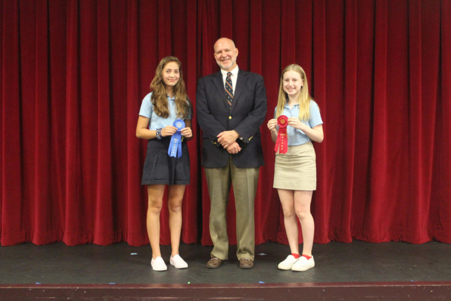 Head of Middle School Mr. Charles Hagy poses with spelling bee champion Emilie Dubiel (left) and runner-up Joie Rodin.