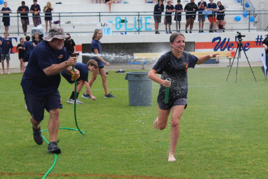 Seventh grader Abby Spunar gets chased down by Coach Kellers hose.