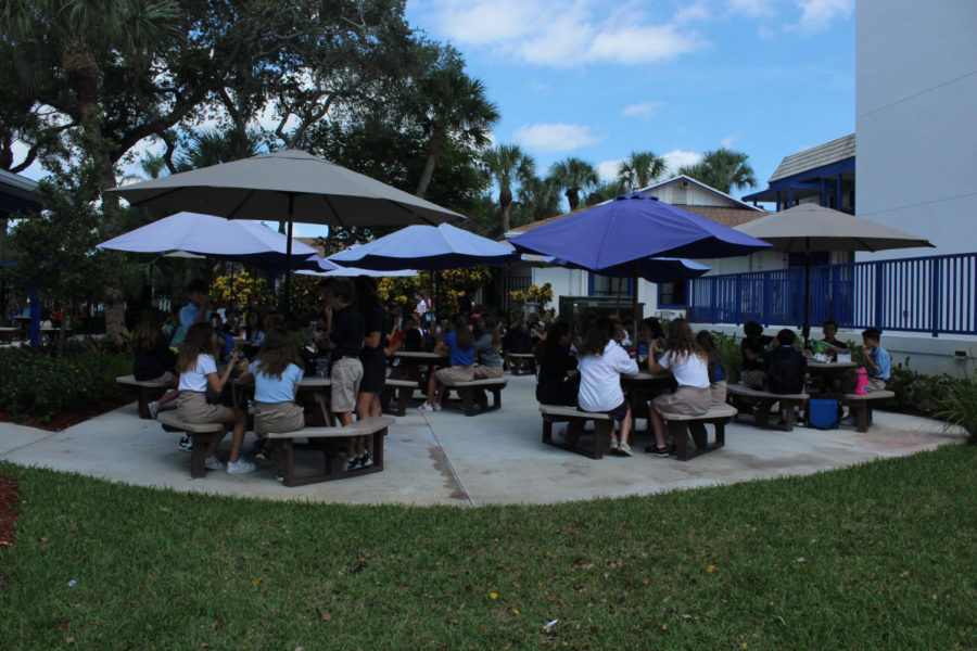 The seventh-grade students have lunch in their assigned seats on October 17.