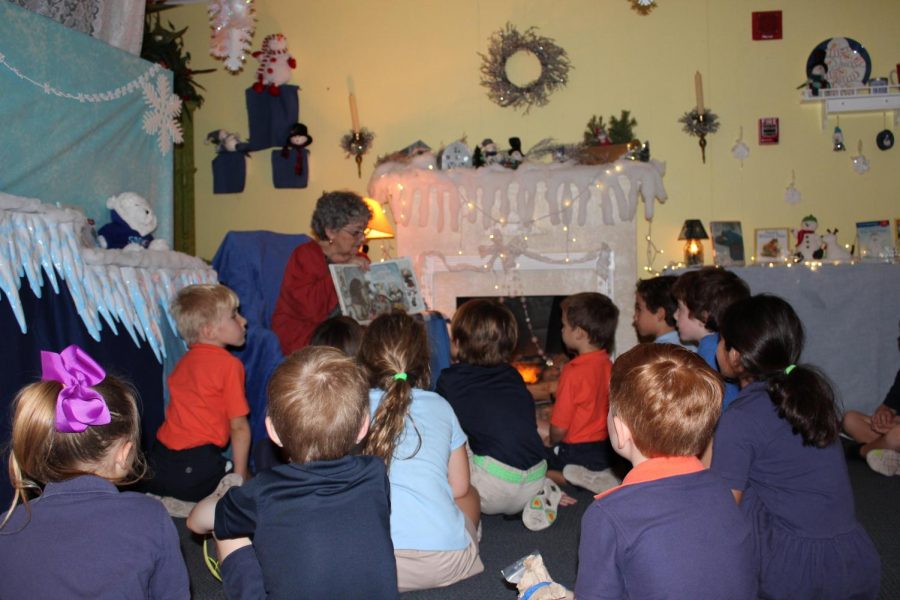 Mrs. Jane Higginbotham reads to her students in the story cottage.