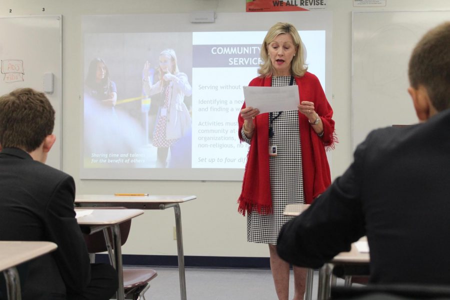 Director of Student Services Mrs. Susan Poncy tells the seventh-grade students what  community service requirements there are for the Congressional Award.