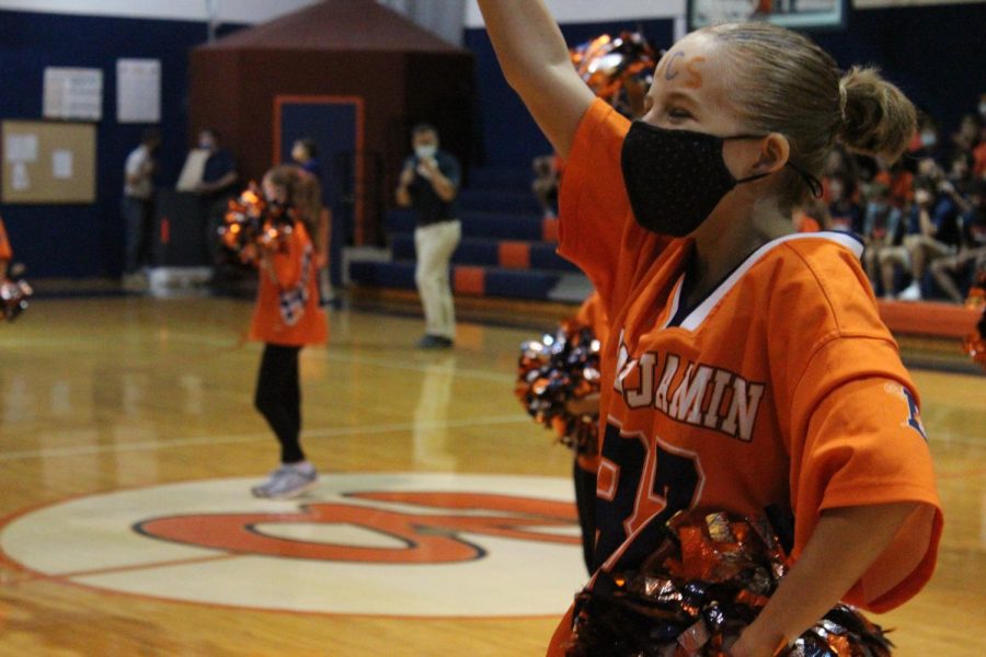 8th grader Bella Blount dances with the rest of the sparklers to BOOM, by X Ambassadors in the gym at the pep rally.