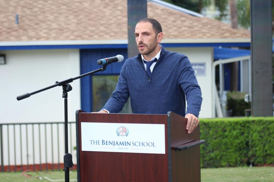 Eighth grade history teacher Mr. Rudolph De Vries addresses the school with a speech about the importance of Veterans Day. (Mr. Crisafi)