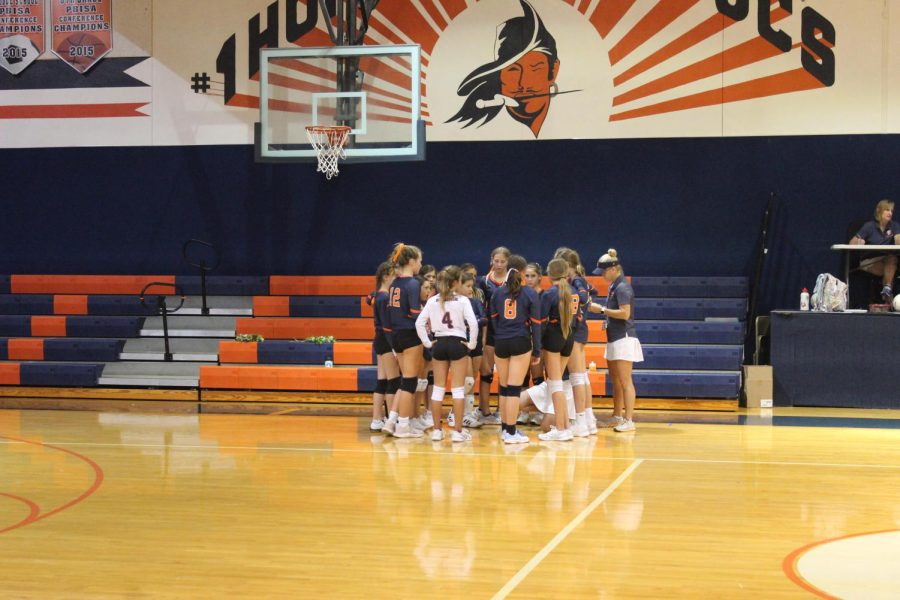 The team are huddled up for a timeout listening to coach Inguagiato tell them the game plan.