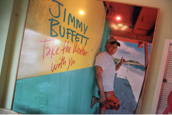 Jimmy Buffett posing in front of a restaurant in the Keys
